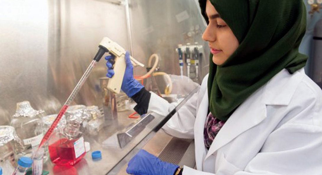 a woman conducting experiments in a lab