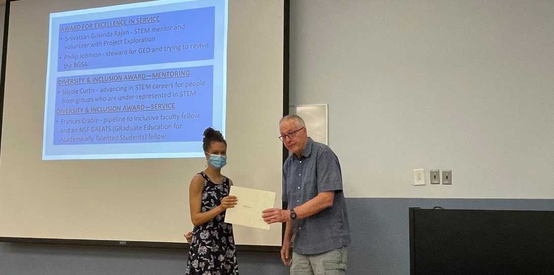 A grad student receives her award