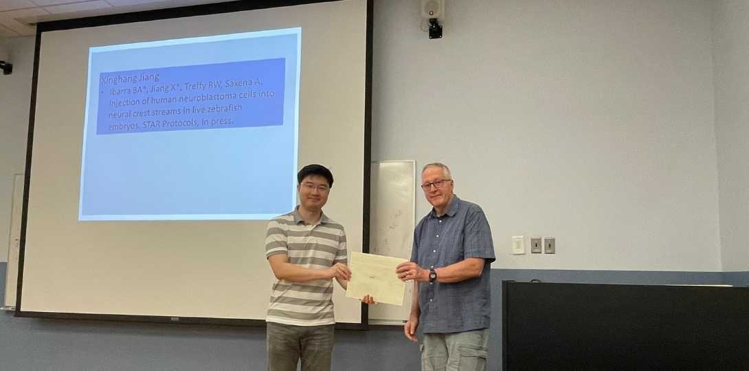 A grad student receives his award