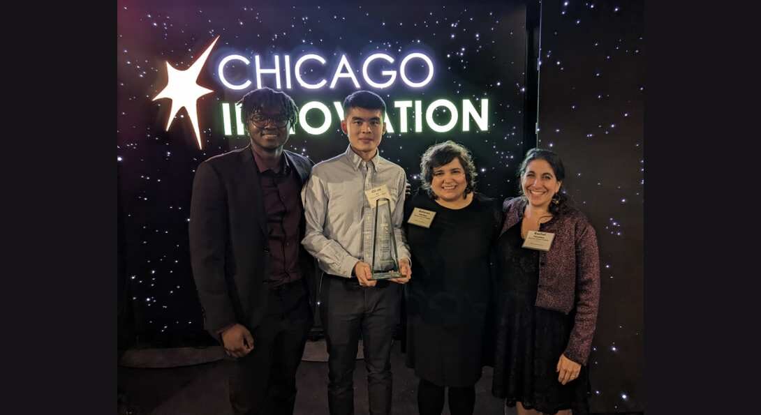 a group of people in front of a neon sign that says Chicago innovation