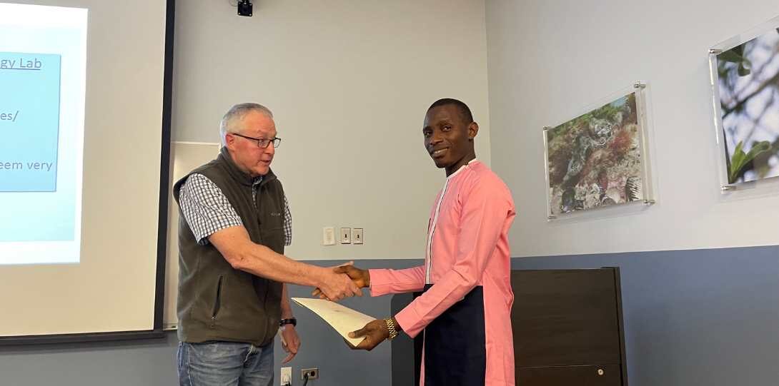 A grad student receives his award